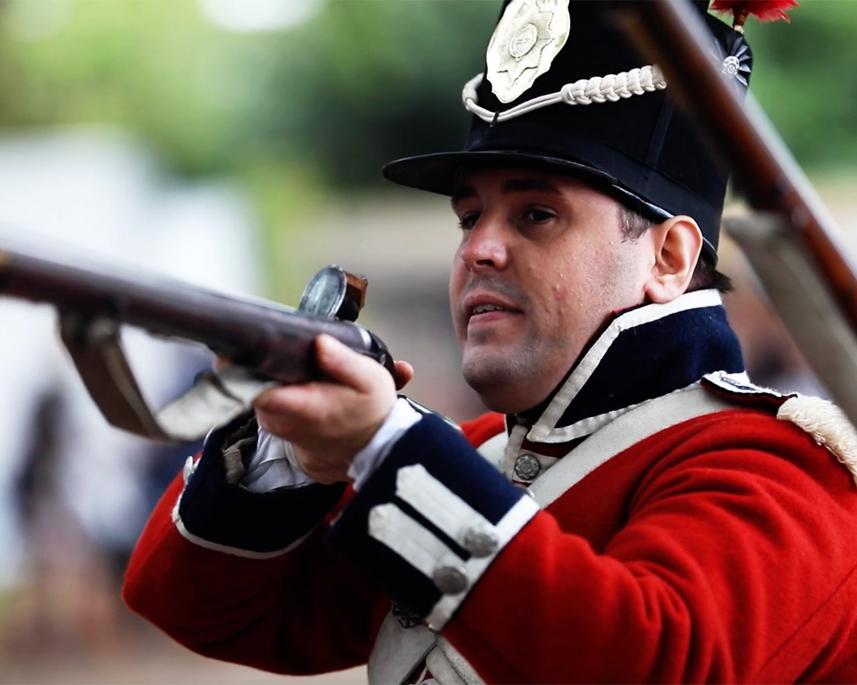 Living historian dressed as a redcoat with musket