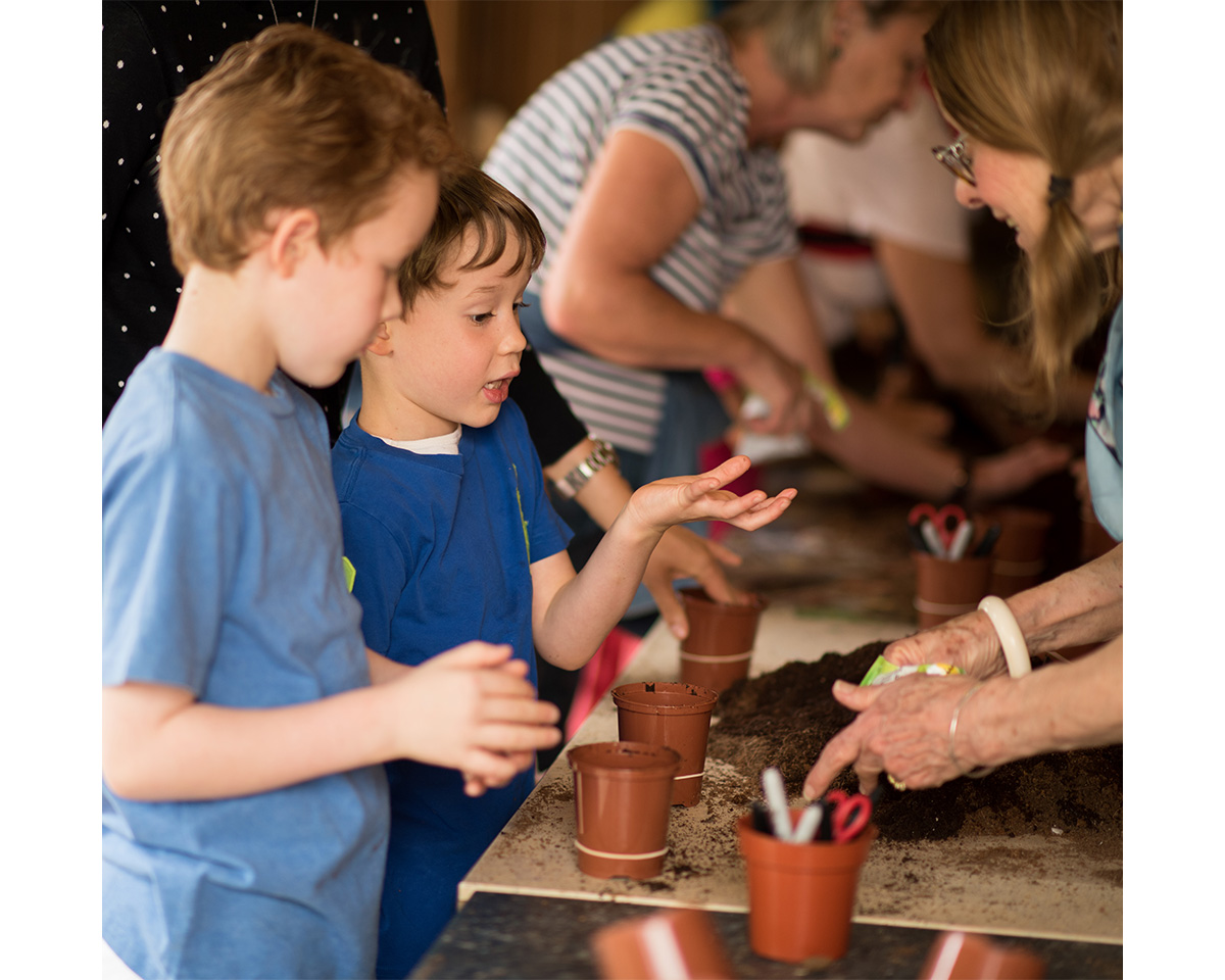 Children planting herbs at Chelsea Physic Garden